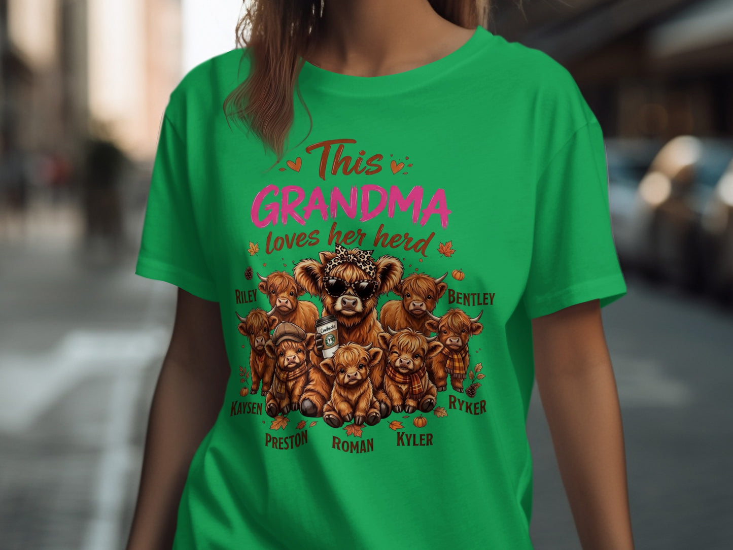 Green t-shirt with "This GRANDMA loves her herd" and illustrated highland cows.