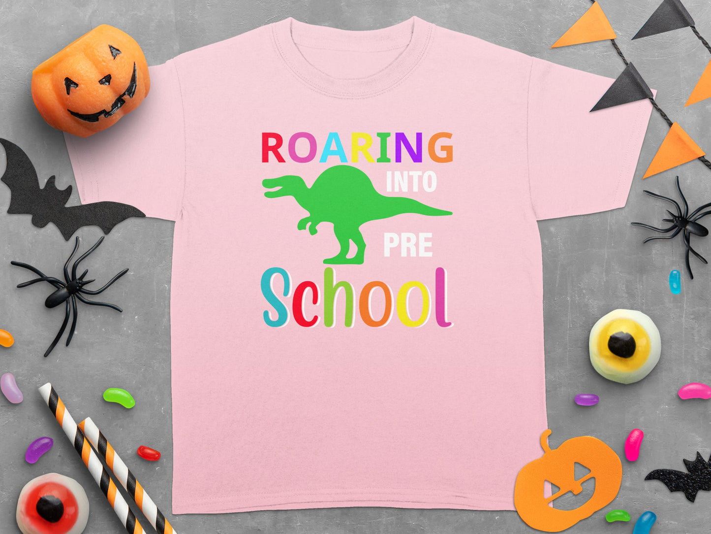 Pink t-shirt with "Roaring Into Pre School" and a green dinosaur graphic.