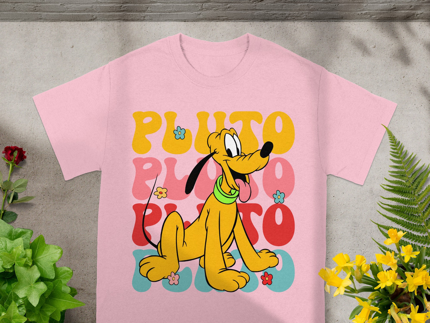 Pink t-shirt with Pluto and colorful "PLUTO" text.