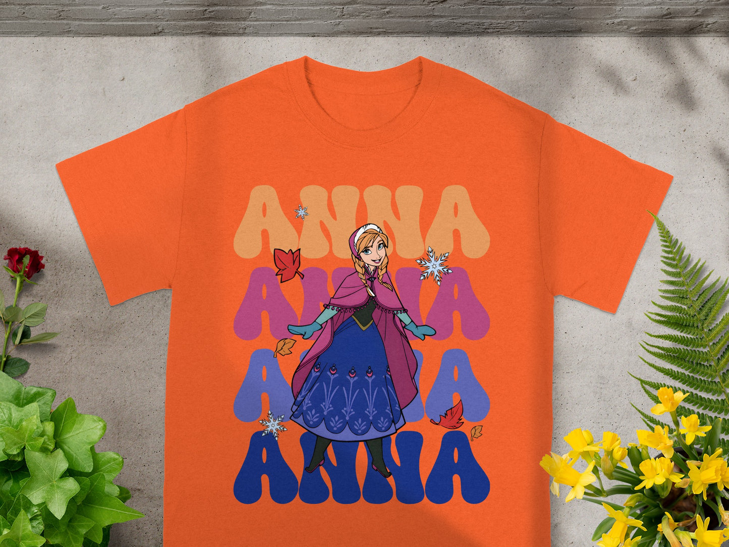 Orange t-shirt with Anna from Frozen graphic and layered text.