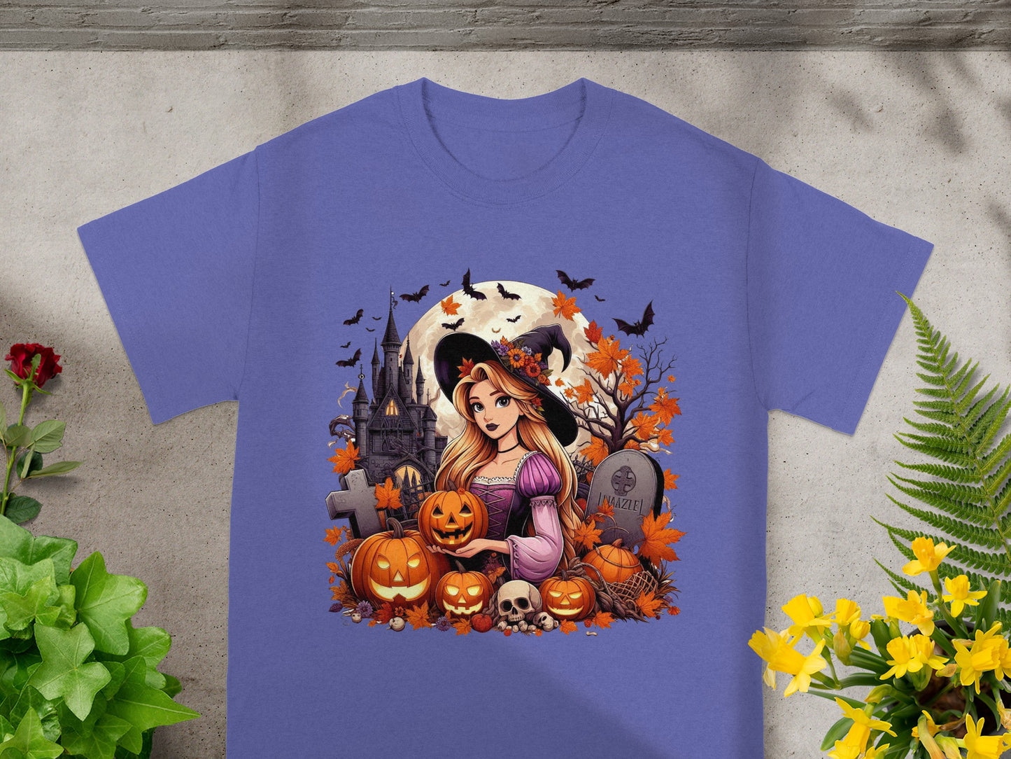 Halloween witch with pumpkins, skull, castle, and bats on a purple t-shirt.