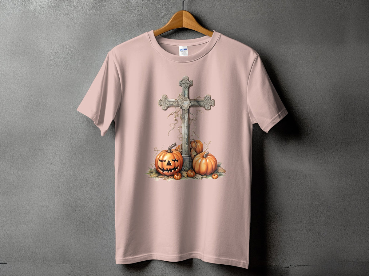 Pink t-shirt with a carved pumpkin and cross Halloween graphic design.