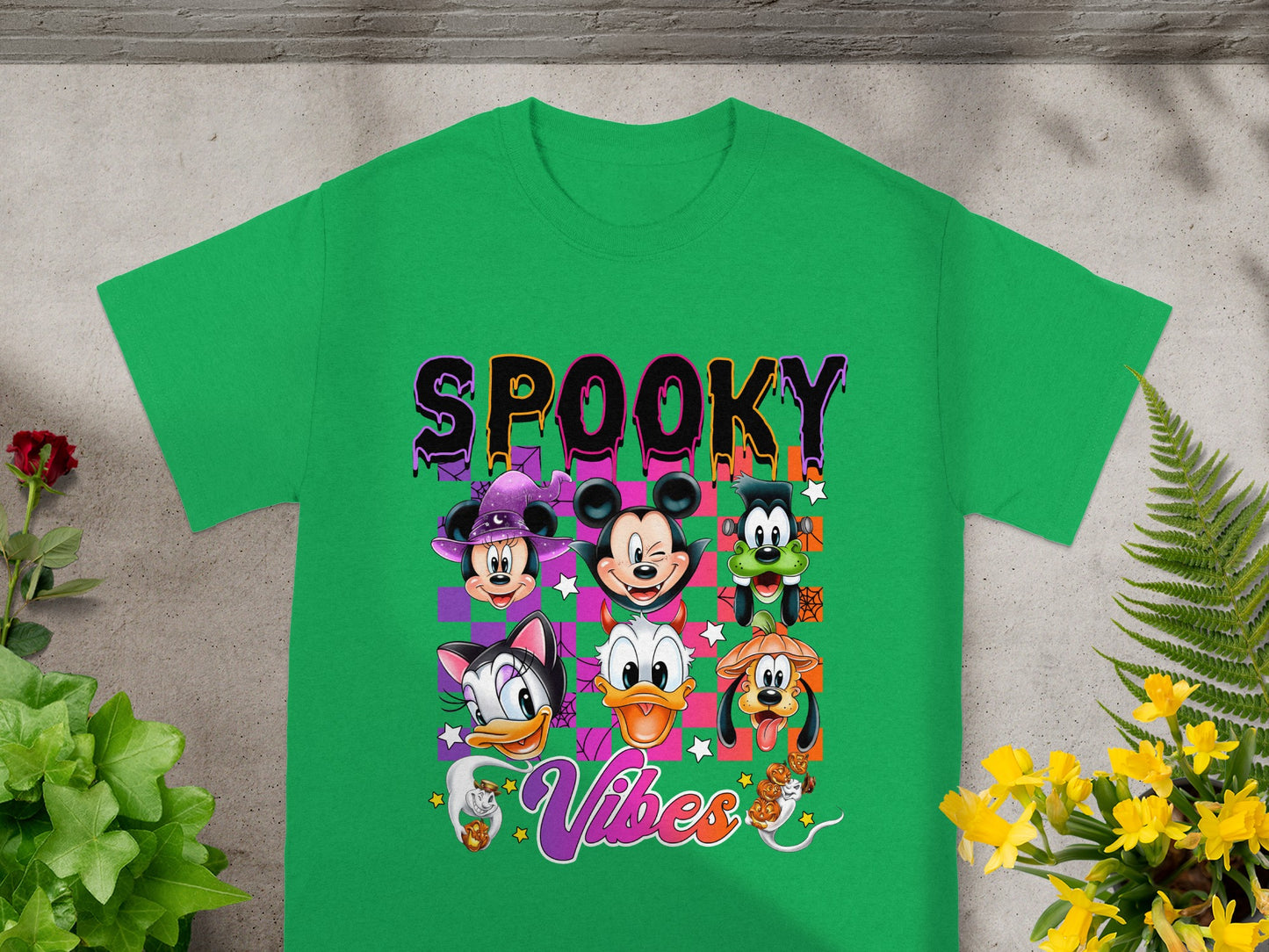 Green t-shirt with Disney characters and "Spooky Vibes" Halloween graphic.
