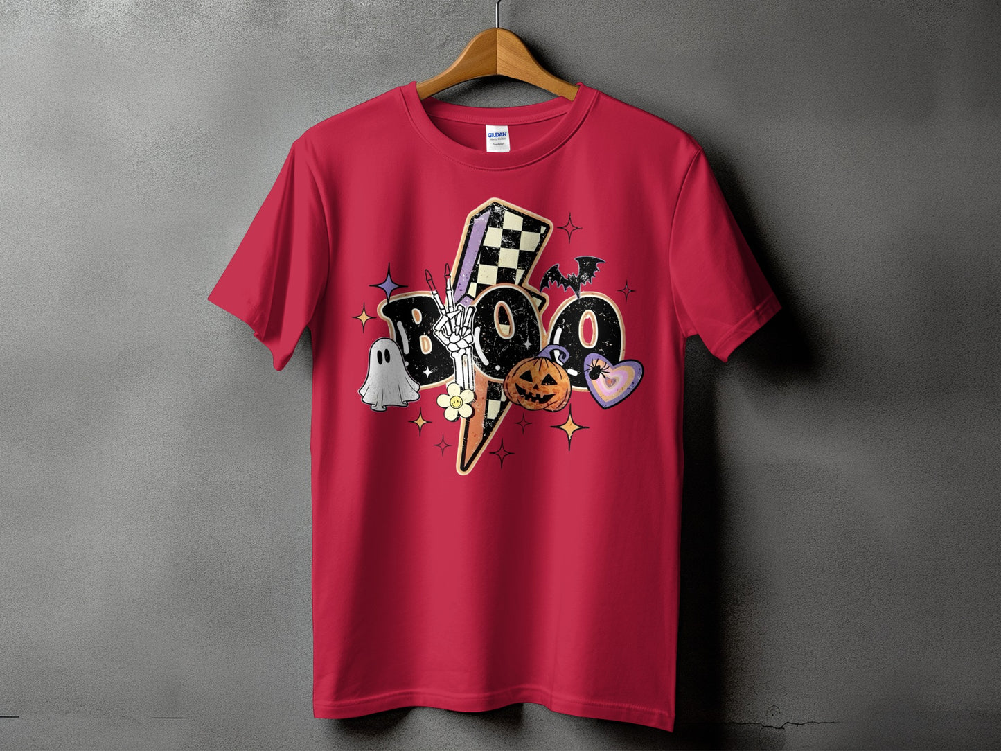 Red t-shirt with Halloween "Boo" graphic featuring skeleton, ghost, pumpkin, bat, and hearts.