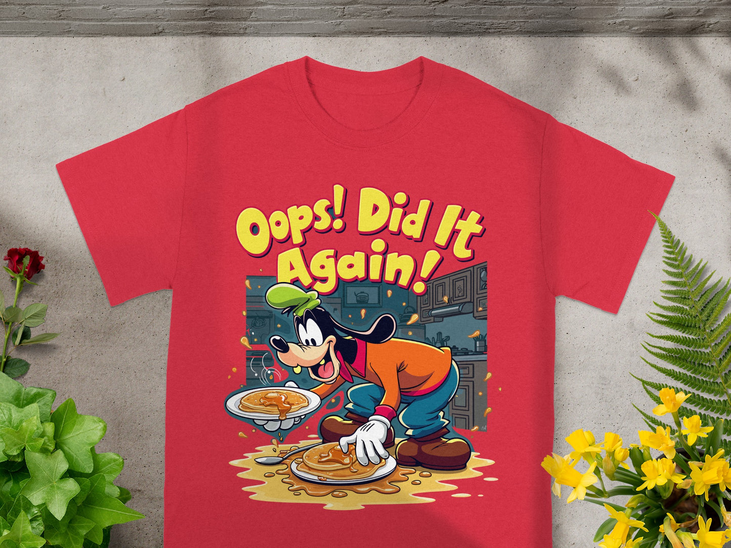 Goofy, wearing an orange shirt and green hat, spills pancakes from a plate.