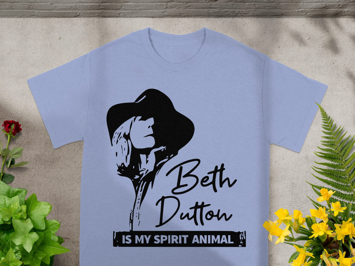 Light blue t-shirt with black graphic of Beth Dutton and text: Beth Dutton is my spirit animal.