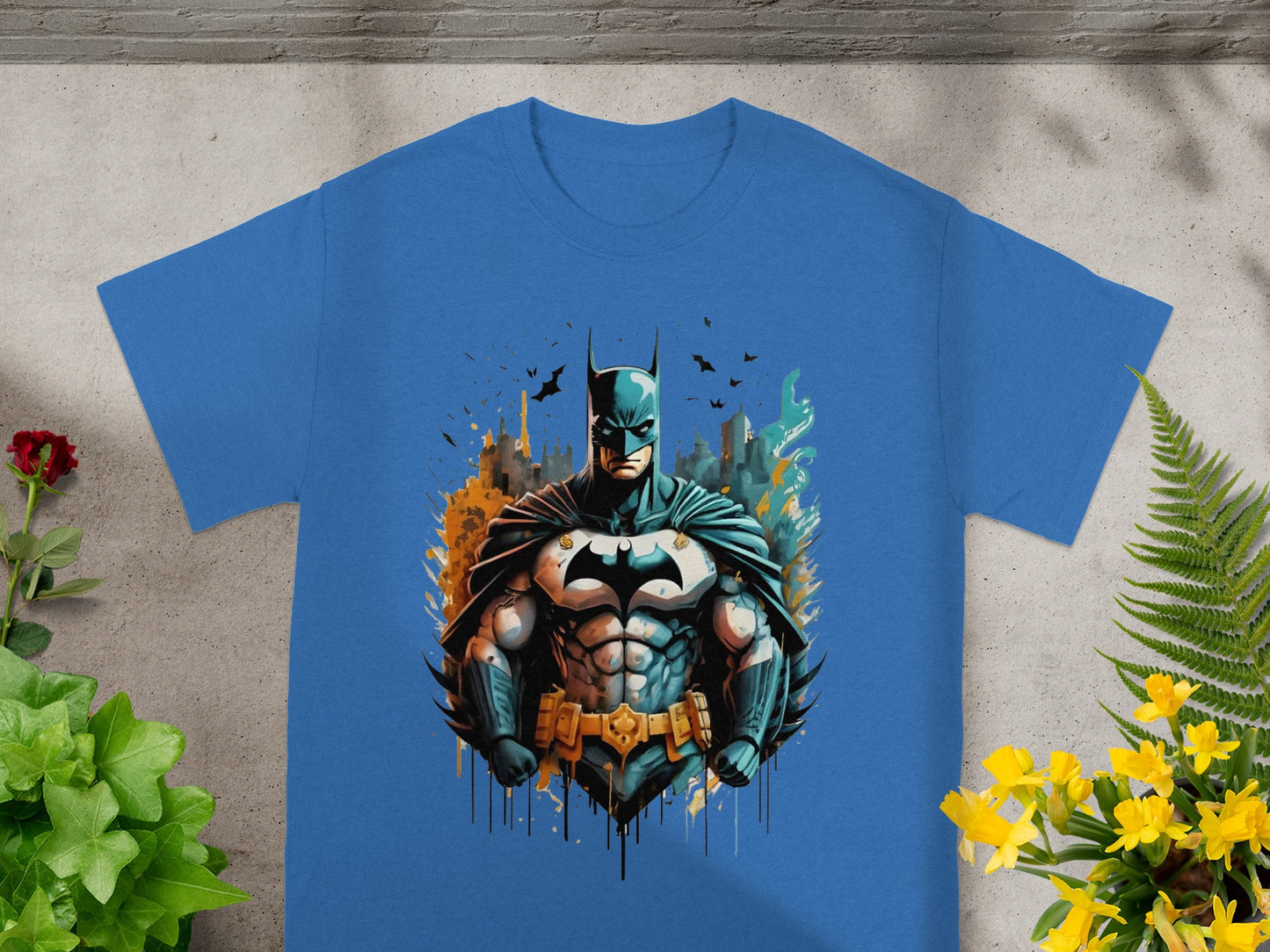 Blue t-shirt featuring a muscular Batman illustration with a city skyline backdrop.