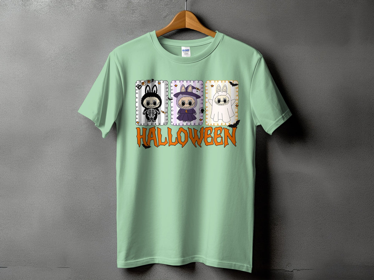 Light green t-shirt with three cartoon Halloween characters and the word HALLOWEEN.