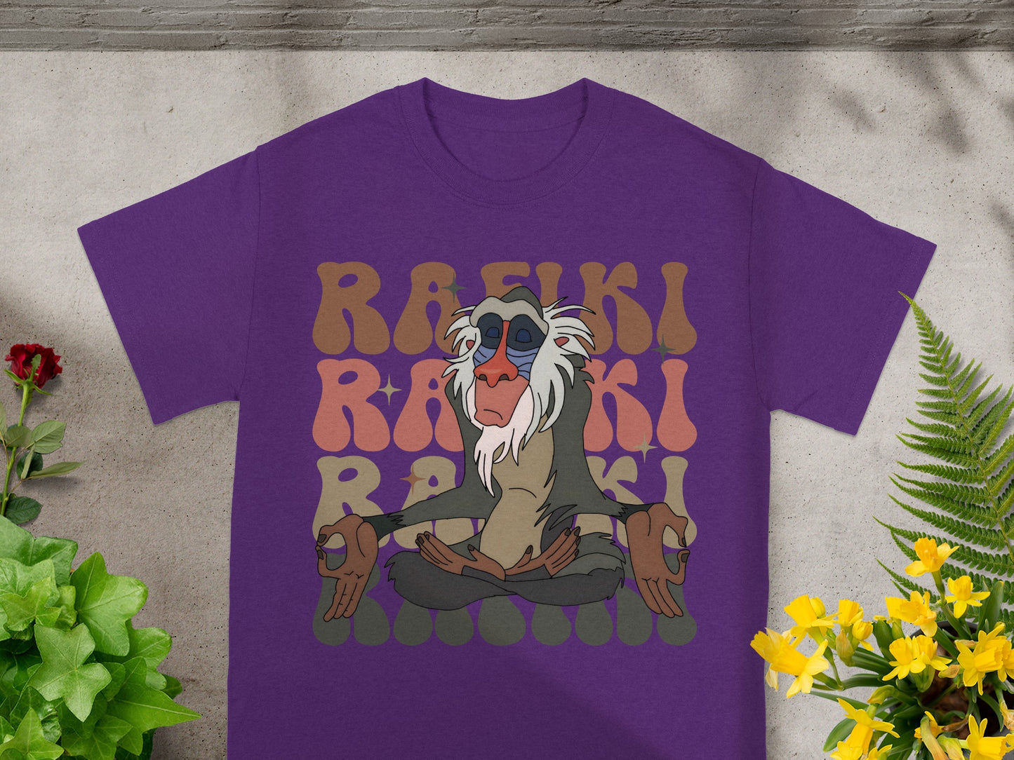 Purple t-shirt with Rafiki meditating and colorful text.