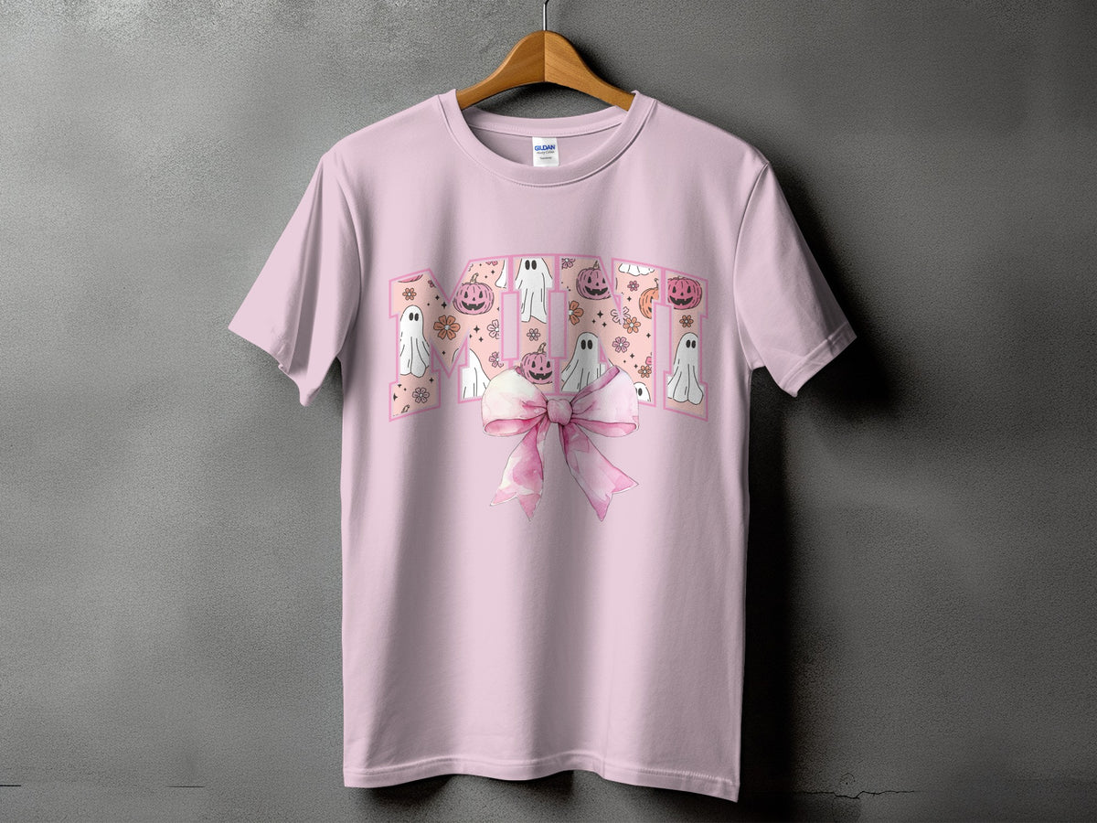 Pink t-shirt with "MOM" in block letters filled with Halloween motifs and a pink bow.