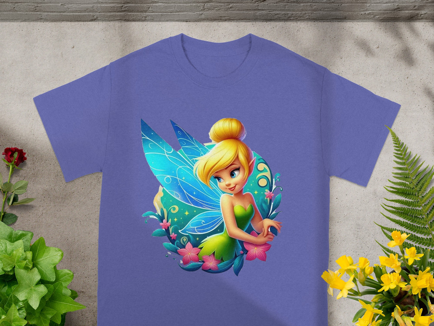 Purple t-shirt with a graphic of Tinkerbell surrounded by flowers and leaves.