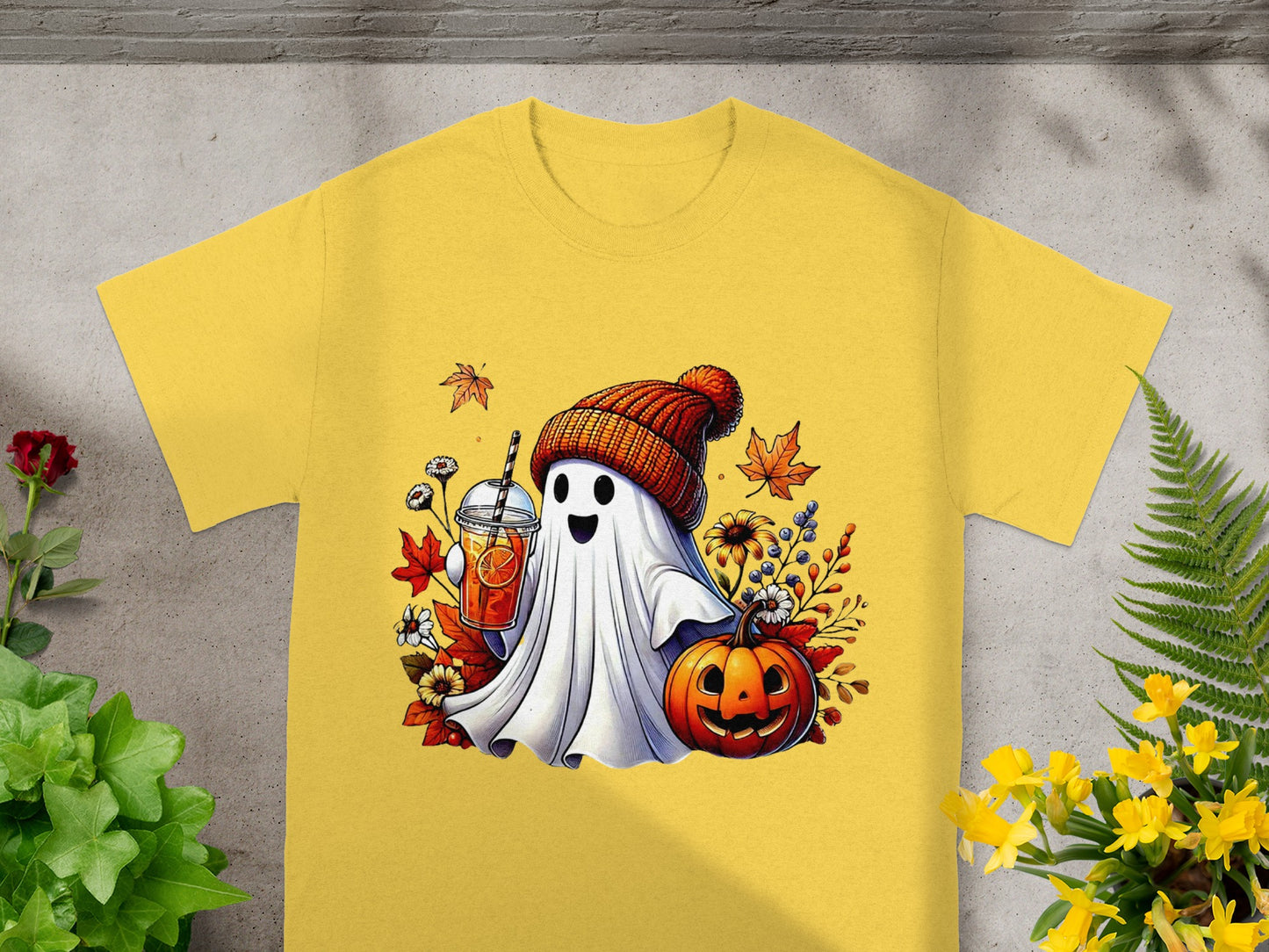 Ghost in beanie holding drink, with pumpkin and autumn leaves.