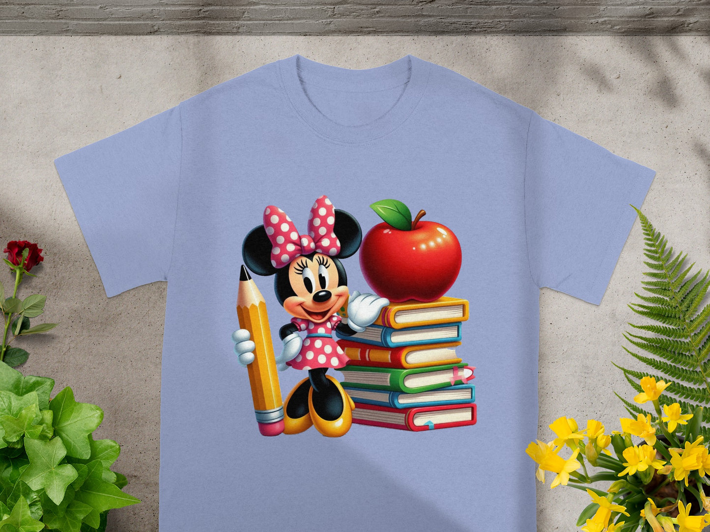 Minnie Mouse holding a pencil beside a stack of colorful books and an apple.