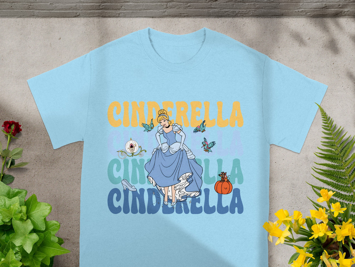 Light blue t-shirt with Cinderella illustration and text.
