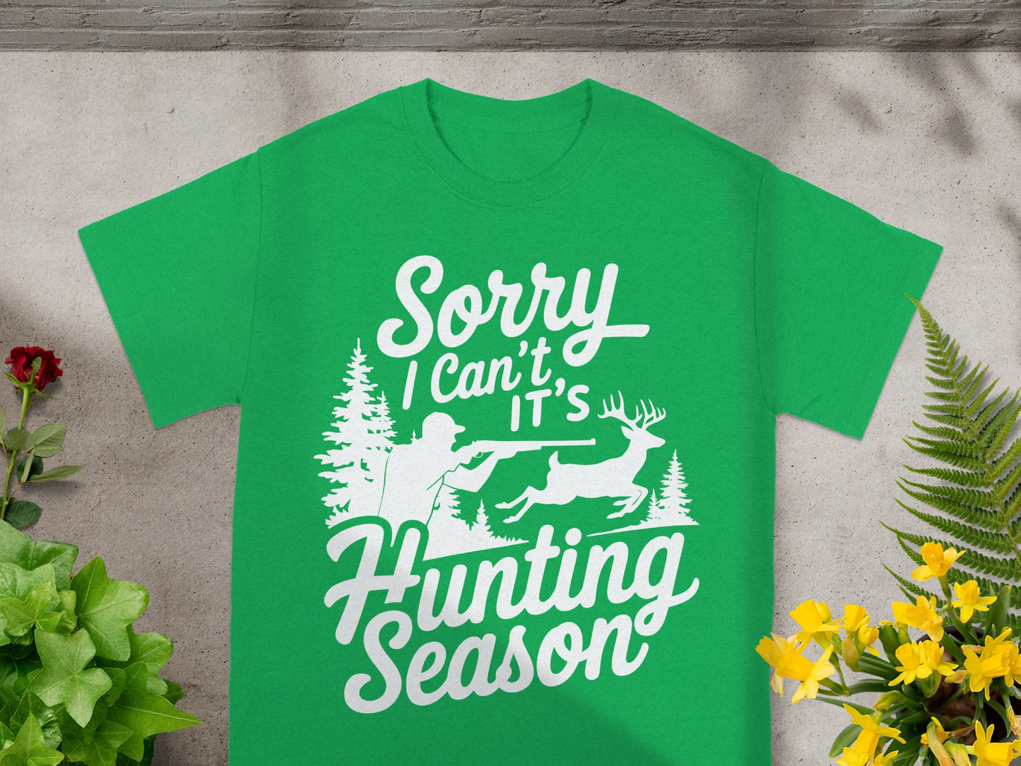 Green t-shirt with white text and graphic of deer hunter and stag.