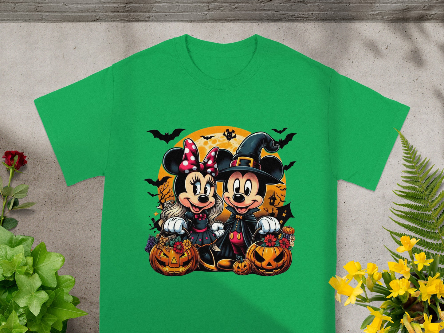Minnie and Mickey Mouse in Halloween costumes with pumpkins and bats on a green shirt.