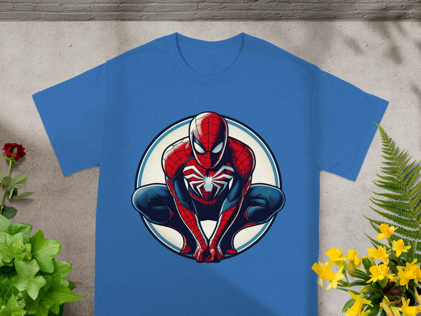Blue t-shirt with Spiderman crouched inside a circular emblem.