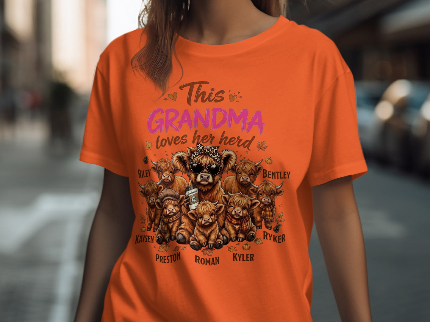 Orange t-shirt with "This Grandma loves her herd" and Highland cows with names.