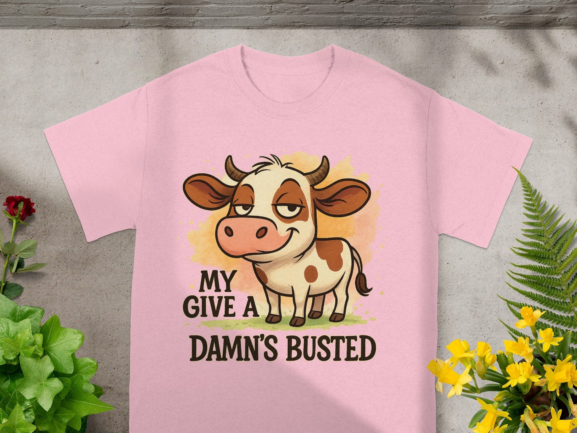 Pink t-shirt with cartoon cow and text "MY DAMN'S BUSTED".