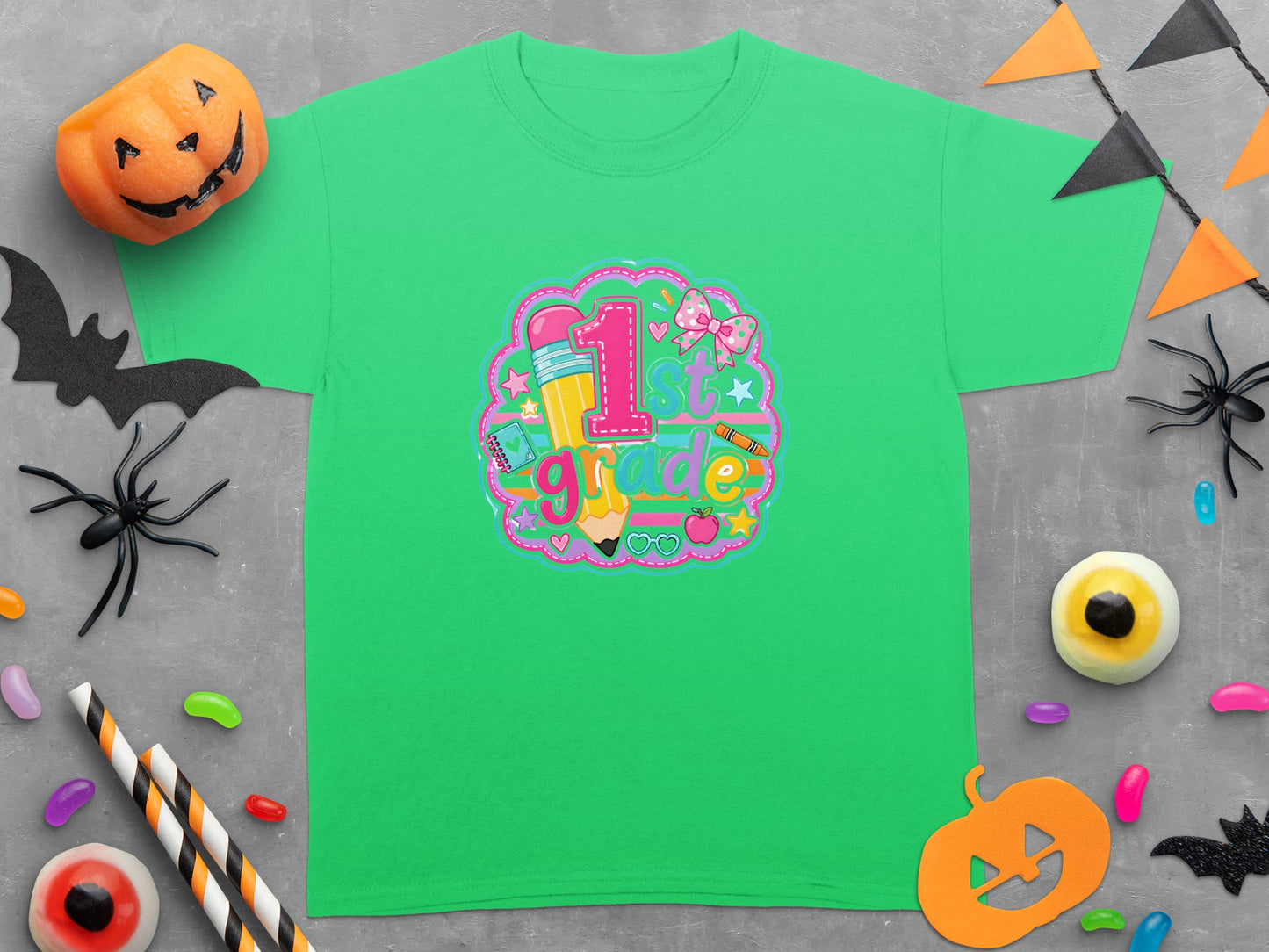 Green t-shirt with "1st Grade" graphic featuring a pencil, ribbon, and school supplies.