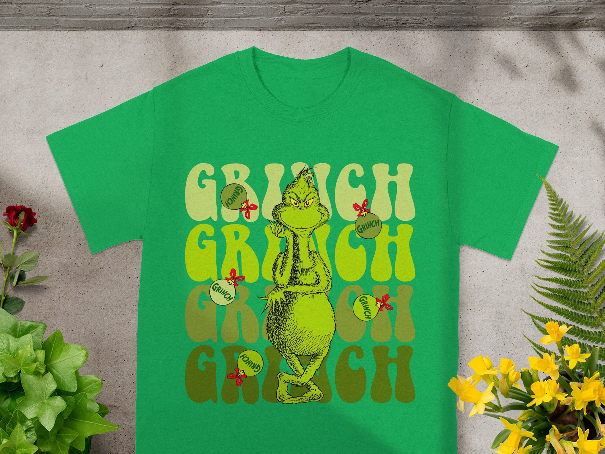 Green t-shirt with "Grinch" text and cartoon Grinch character.
