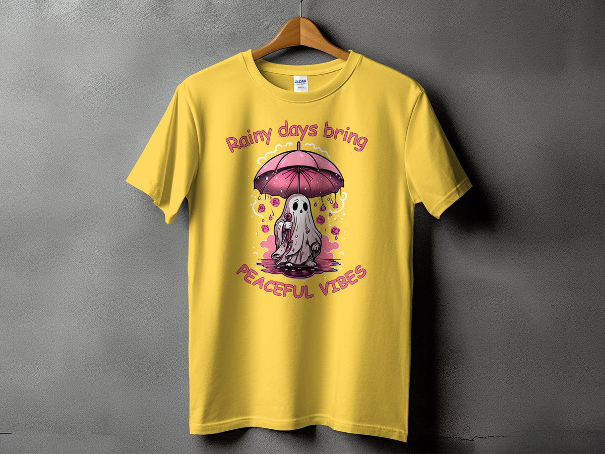 Yellow t-shirt with a ghost holding an umbrella and text "Rainy days bring peaceful vibes".