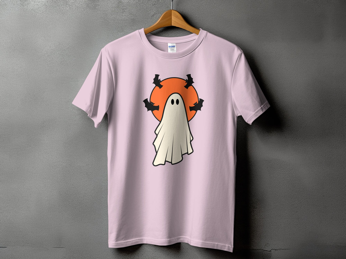 Pink t-shirt with ghost and bats Halloween graphic.