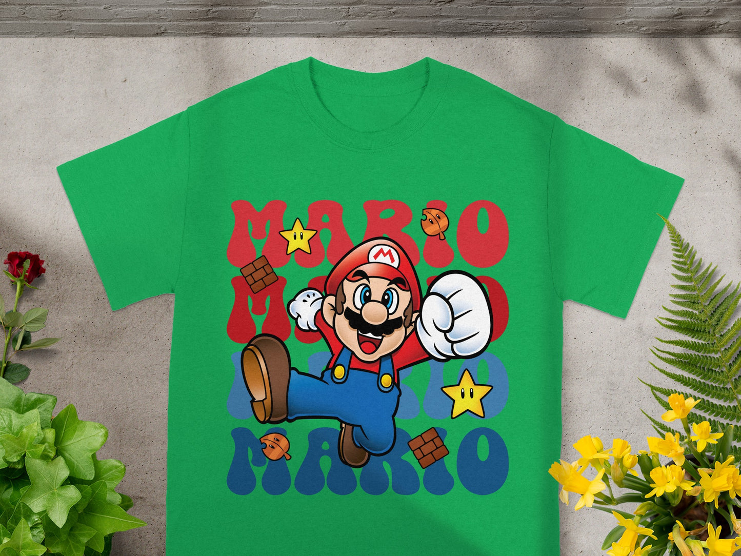 Green t-shirt with Mario, stars, and text "MARIO" in red and blue.