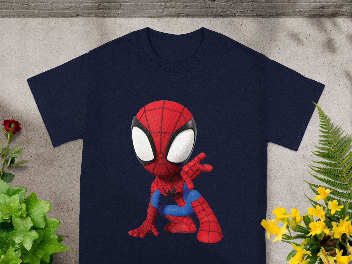 Navy t-shirt with a cartoon Spiderman graphic in a crouching pose.