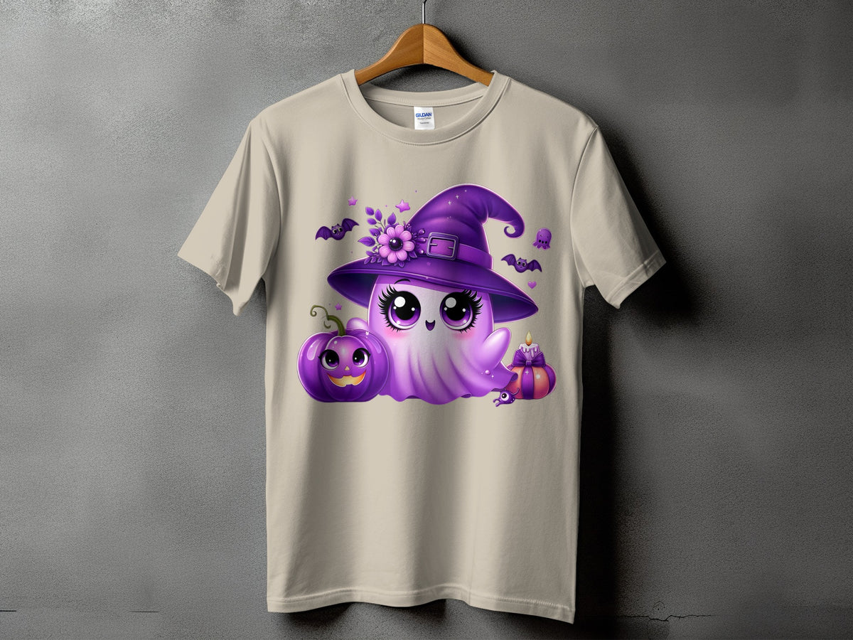 Ghost with witch hat and Halloween decorations on a tan t-shirt.