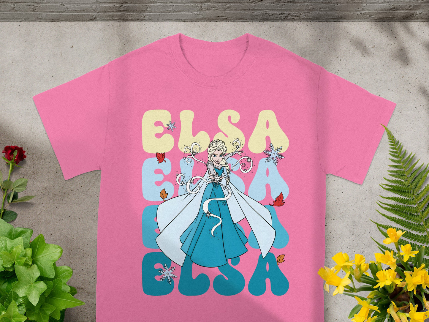 Pink t-shirt with Elsa illustration and "ELSA" text in large letters.