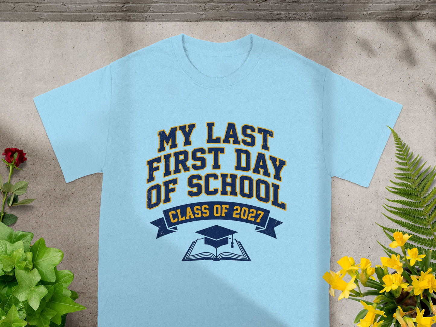 Light blue t-shirt with "My Last First Day of School" and "Class of 2027" text.