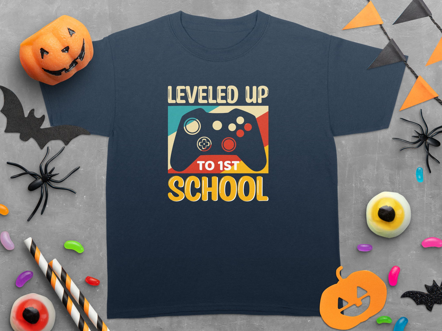 Navy t-shirt with "Leveled Up To 1st School" text and a video game controller graphic.