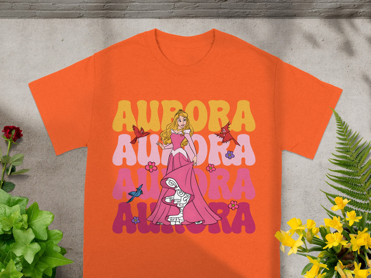 Orange t-shirt with "Aurora" text and Princess Aurora in pink dress.