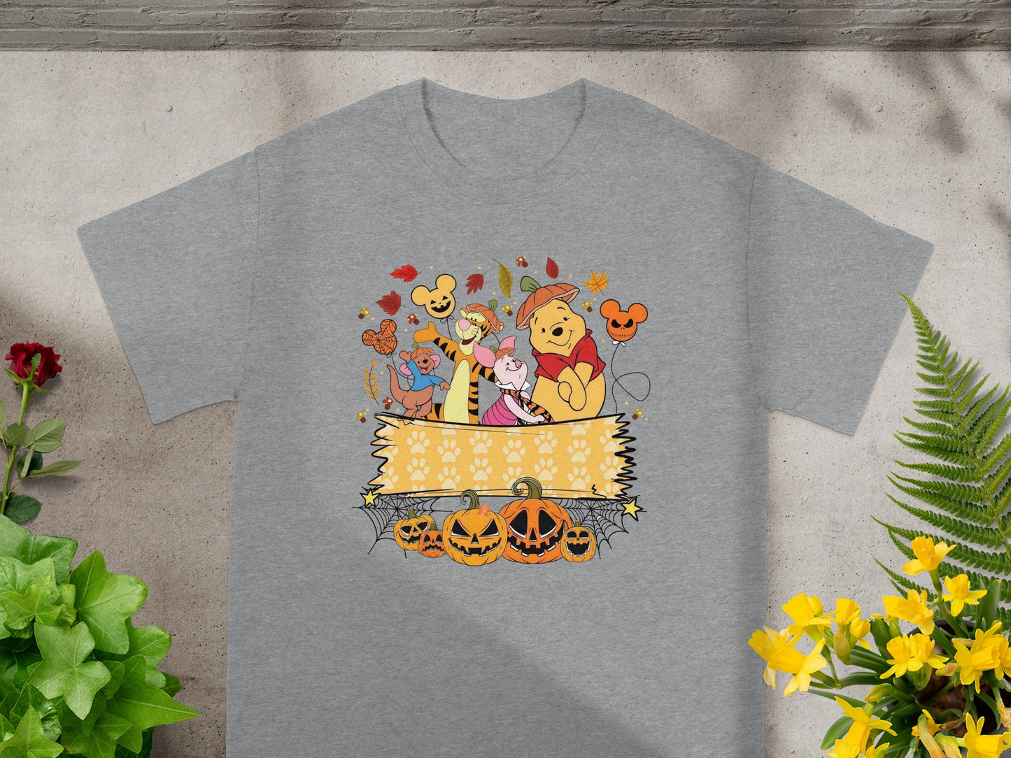 Winnie the Pooh and friends in Halloween costumes with pumpkins and autumn leaves.