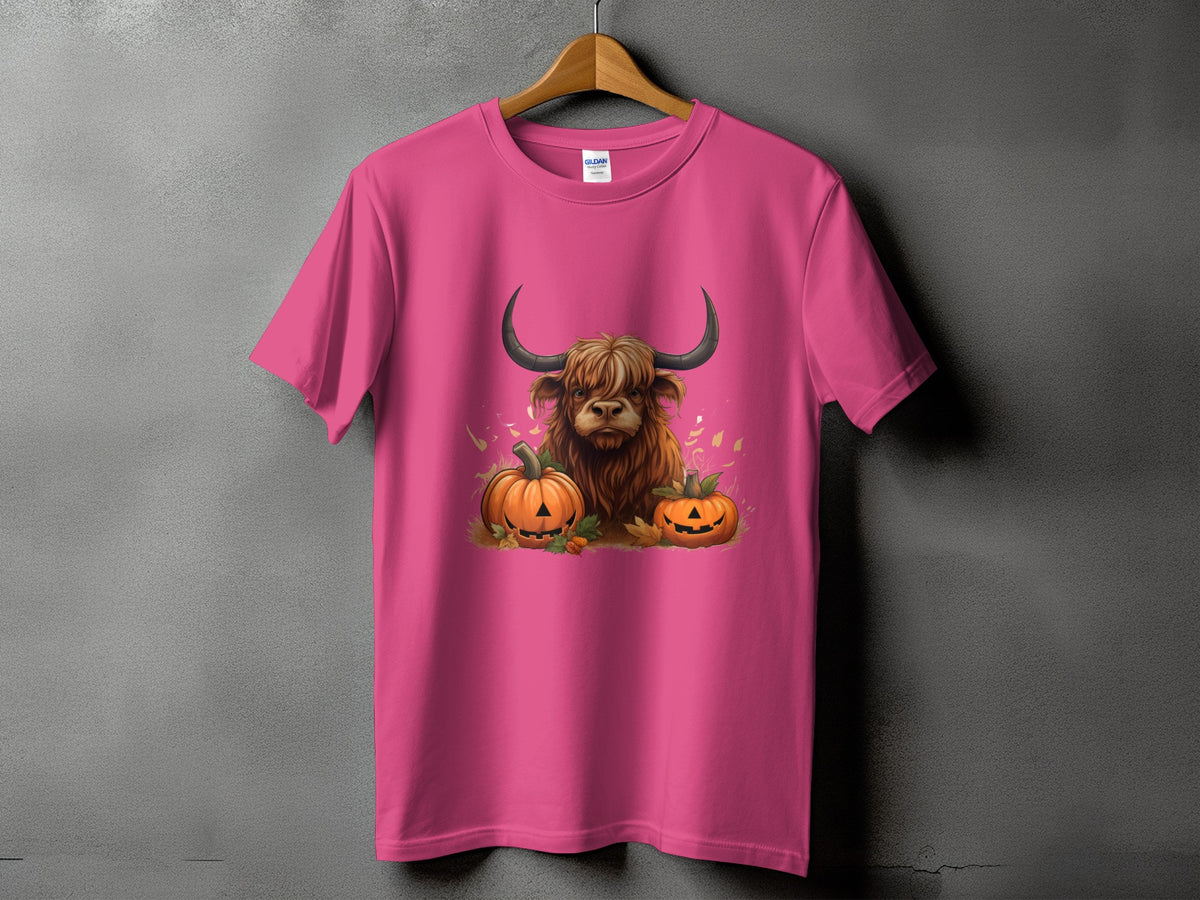 Pink t-shirt with a Highland cow and pumpkins graphic.
