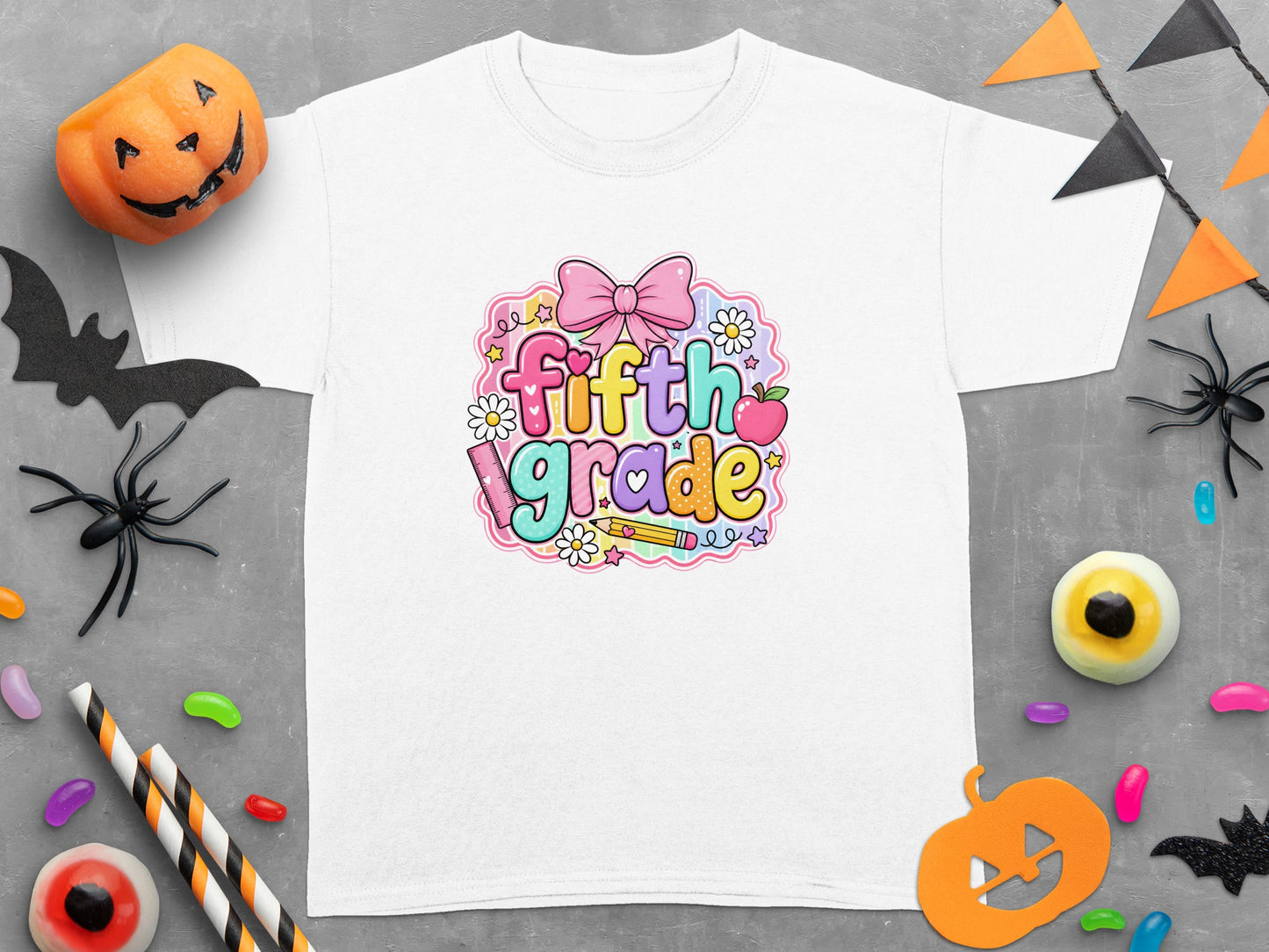 White t-shirt with "fifth grade" text and Halloween decorations.