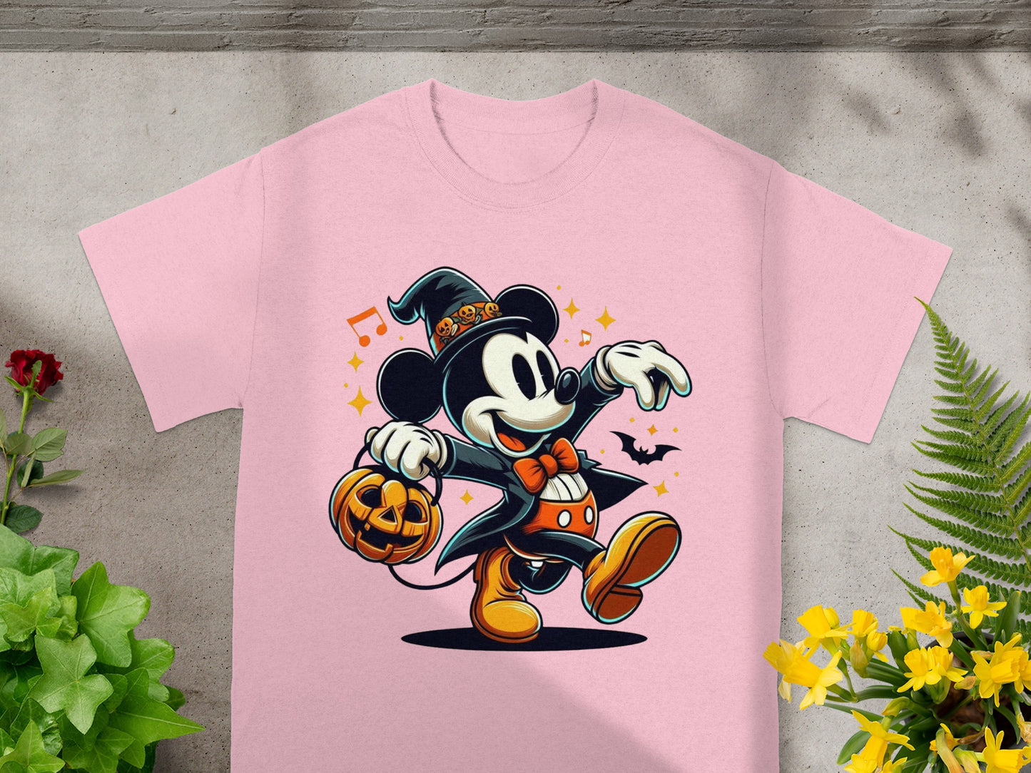 Pink t-shirt with Mickey Mouse in a witch hat holding a pumpkin.