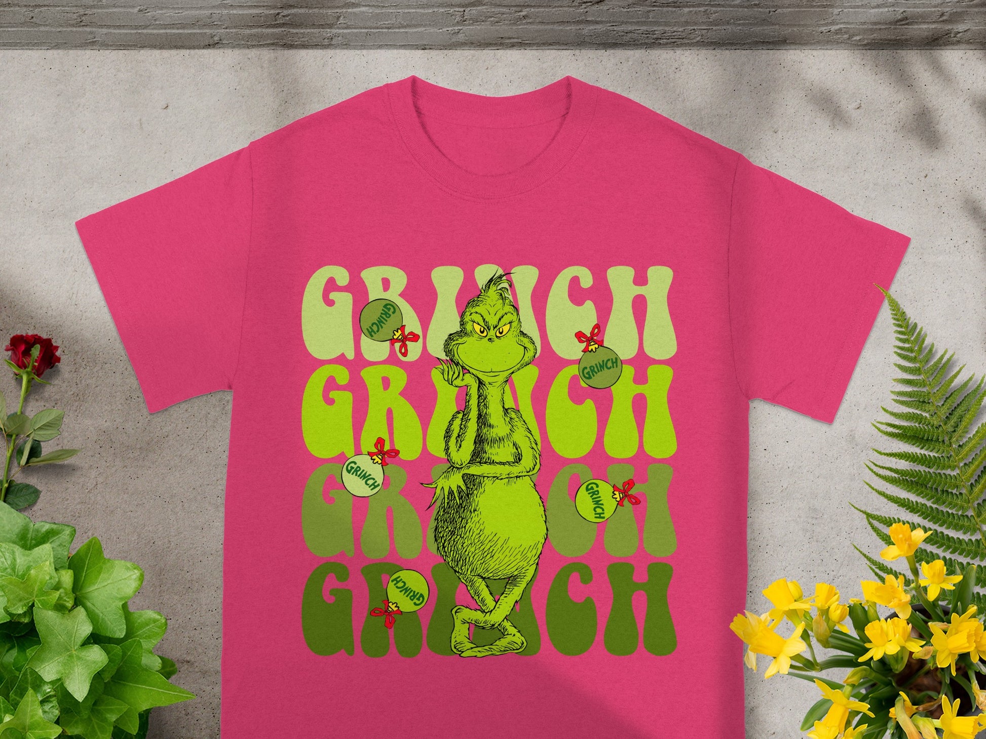 Pink t-shirt with Grinch graphic and lettering.