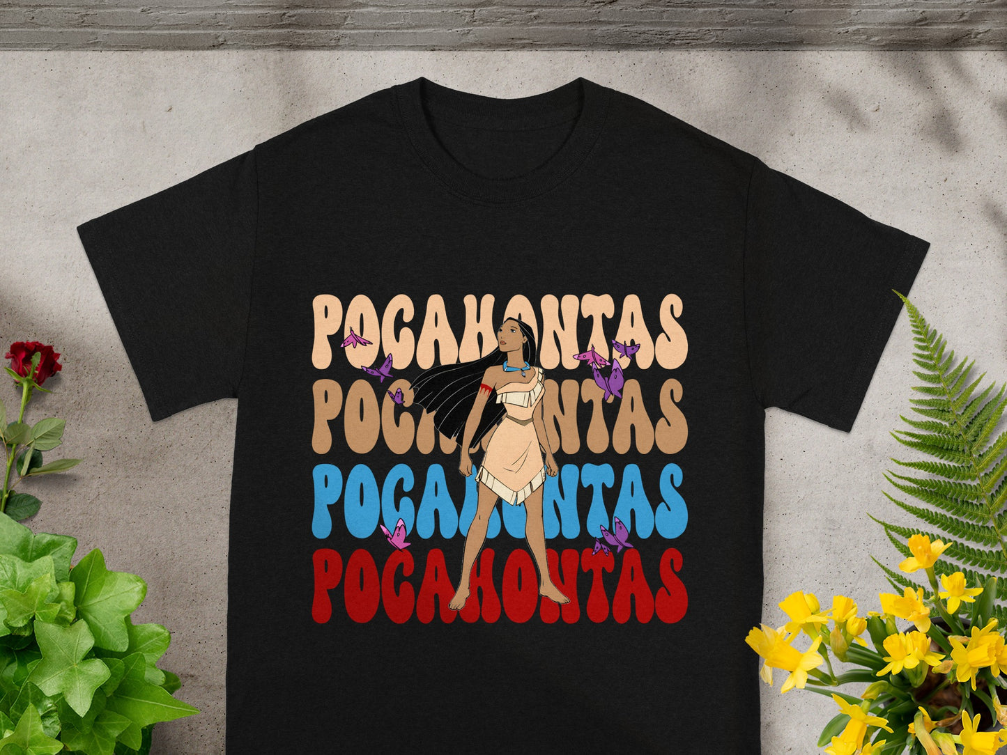 Black t-shirt with "Pocahontas" text in colorful, retro font and a silhouette.