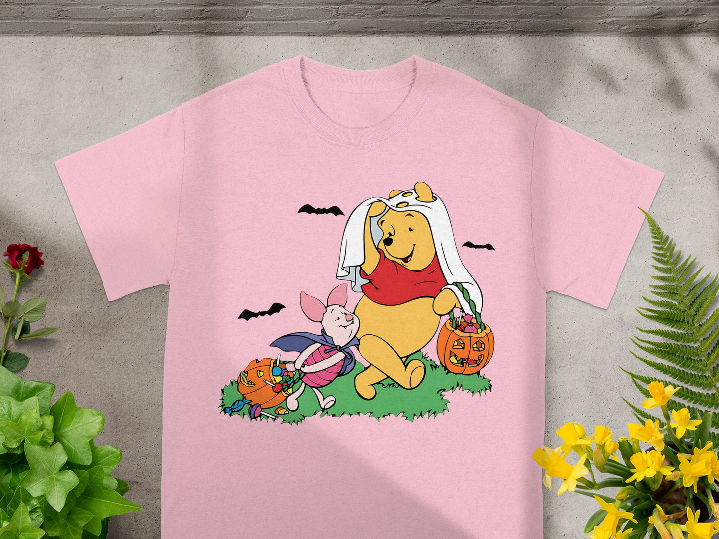 Winnie the Pooh and Piglet in Halloween costumes collecting candy from pumpkins.