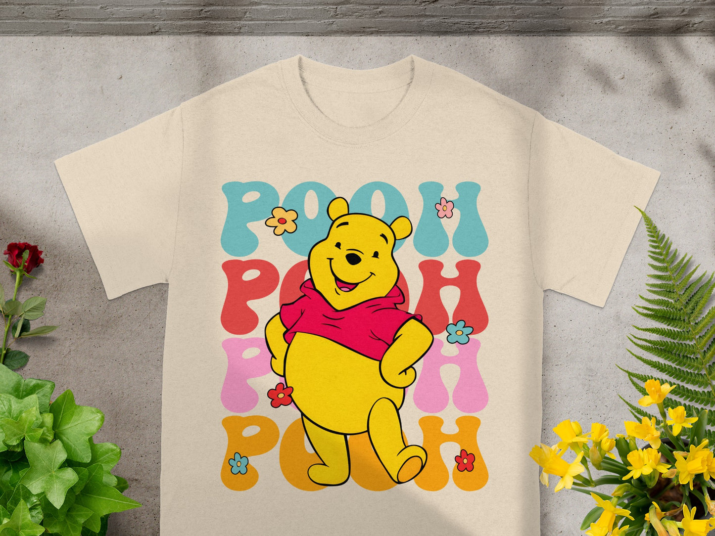 Winnie the Pooh graphic on a cream t-shirt.
