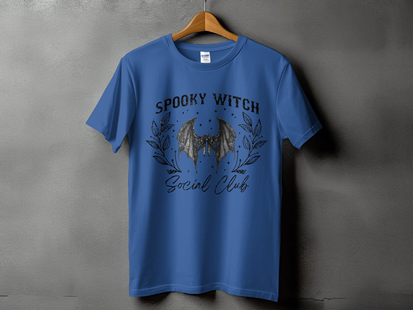 Blue t-shirt with "Spooky Witch Social Club" text and a bat graphic.