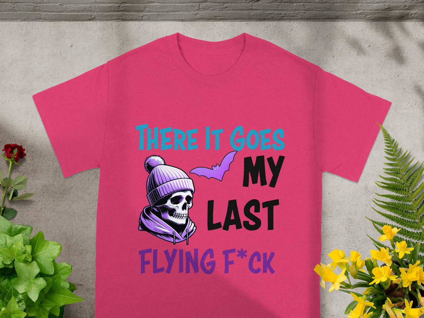 Pink t-shirt with skull wearing a beanie and text "There it goes my last flying f*ck".
