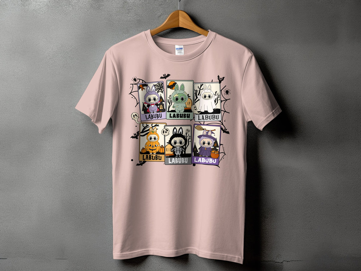 Pink t-shirt with six "Labubu" Halloween character squares and spiderweb graphics.