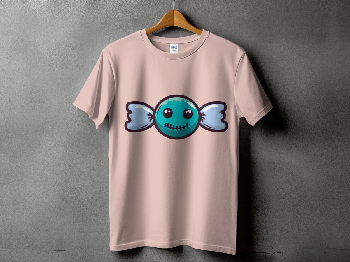 Pink t-shirt with a cartoon blue candy featuring a stitched mouth and large eyes.