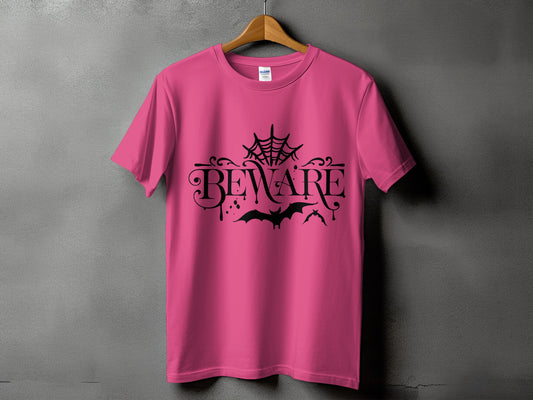 Pink t-shirt with black "BEWARE" text, spiderwebs, and bats design.