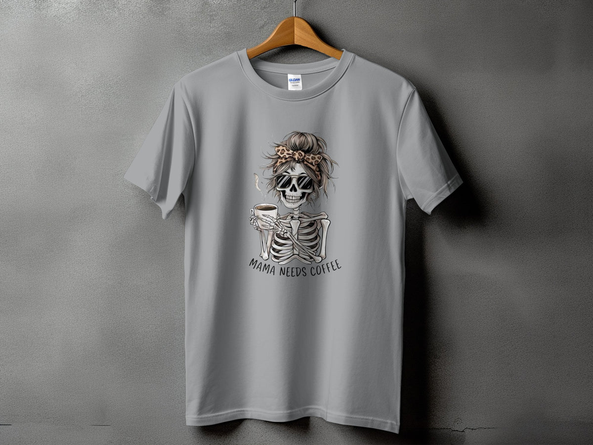 Grey t-shirt with skeleton graphic holding coffee, text "Mama Needs Coffee."