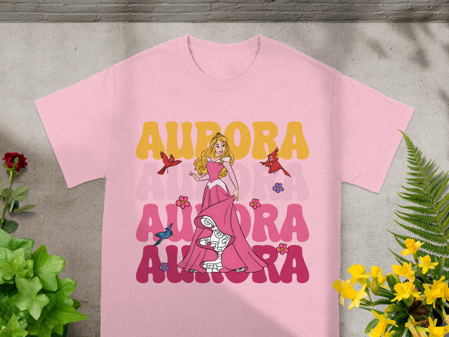 Pink t-shirt with Aurora, two birds, and pink floral accents.