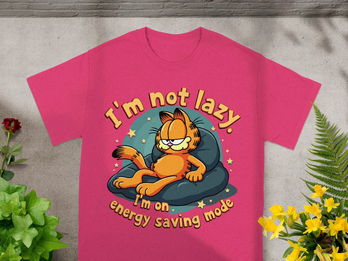 Pink t-shirt with Garfield lying on a cushion, text "I'm not lazy. I'm on energy saving mode."